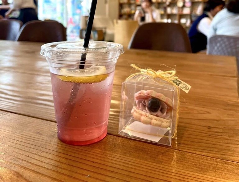 ピンク色のマカロンと飲み物が映っている写真