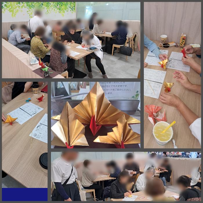 シニアカフェ・イン・アピタに集まって、祝い鶴を折る皆さん。中央は完成品