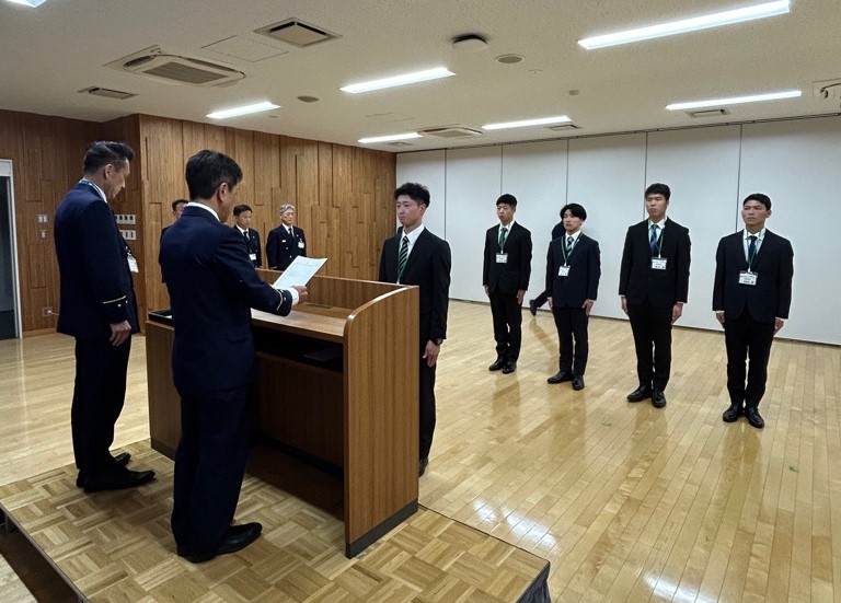 檀上を挟んで消防長から男性職員が辞令を受け取っている辞令交付の様子の写真